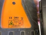 a close up of a laser level with a hand holding it