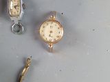 three different types of watches sitting on a table