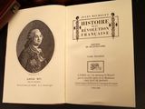 an open book with a picture of a man in a suit and tie