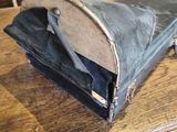 a black bag sitting on top of a wooden table