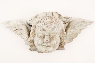a statue of an angel with wings on it ' s head