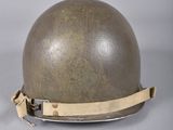 two helmets are sitting on top of each other on a table