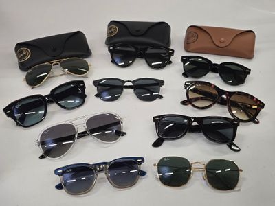 several pairs of sunglasses and a case sitting on a table