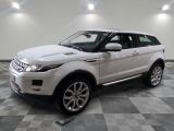 a picture of a white land rover parked in a garage