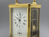 an image of a gold clock with roman numerals on the face