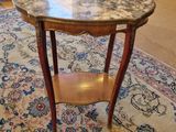 a small table with a marble top in a living room