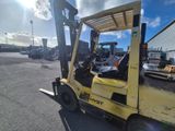 a yellow fork truck that is parked in the parking lot