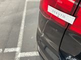 a sticker on the back of a car that is parked in a parking lot