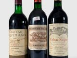 trois bouteilles de vin posées l'une à côté de l'autre sur une table
