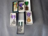 five medals and a medal in a box on a table
