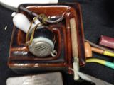 a picture of a small tray with a toothbrush, toothbrushes, and a lighter
