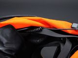 a black and orange bag with a phone in it
