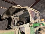 a green truck that is parked inside of a building