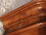 a close up of a corner of a wooden cabinet