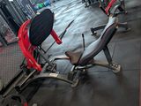 a gym area with a bench, weights, and other equipment