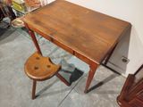 a small wooden desk with a wooden chair in front of it