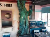 a statue of liberty on the wall of a restaurant