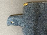 a small piece of denim with a hole in it