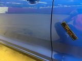 a sticker on the door of a blue car