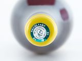 a close up of a yellow and white ball with a red dot on it