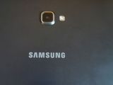 a close up of the back of a black samsung phone