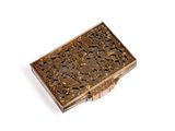 an antique brass cigarette case with a floral design on the front
