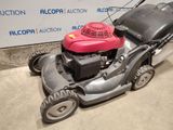 a lawn mower that is sitting on the ground
