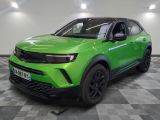 a green suv parked on a checkered floor in a garage