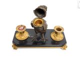 a black and gold candle holder with a bird on it