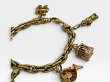 a close up of a gold bracelet with charms on it