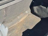 the interior of a car with the door open and the seat folded down