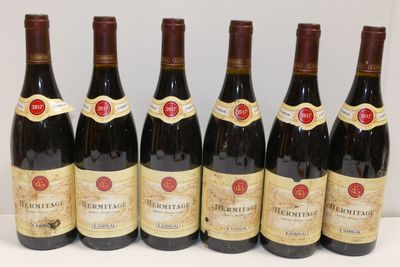six bouteilles de vin sont alignées sur une table