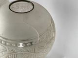 a silver vase that is sitting on a table