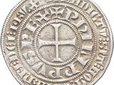 a close up of a coin with a cross on it