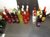many bottles of alcohol lined up on the counter