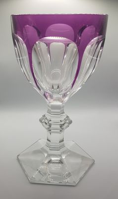 a purple wine glass sitting on top of a table