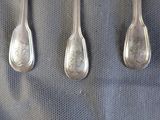 three spoons that are sitting next to each other on a table