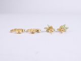 a pair of gold earrings with green stones on them