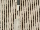 a toothbrush and a tooth brush on a striped rug