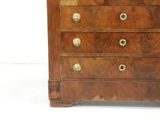 a wooden chest of drawers with a clock on top of it