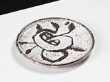 a white plate with a drawing of a bear on it