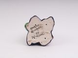 porcelain figurine of a butterfly with a message on it