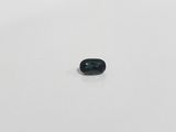 an oval blue sapphire stone on a white surface