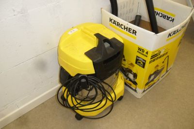 a yellow and black vacuum next to a white bucket