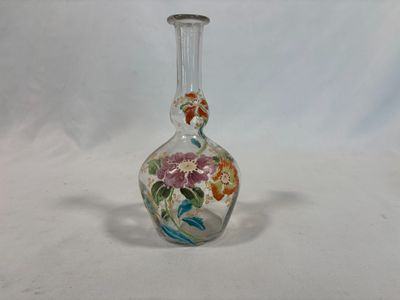 a small glass vase with a floral design on it
