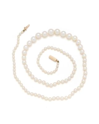 a white pearl necklace and bracelet set with a gold clasp