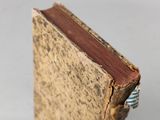 a close up of a book with a ring on top of it