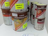 several buckets of paint sitting on top of a white table