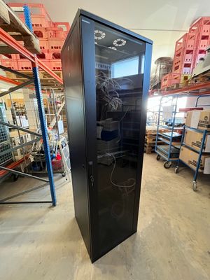 an image of a black refrigerator in a warehouse