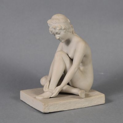 statue of a woman sitting on a marble base